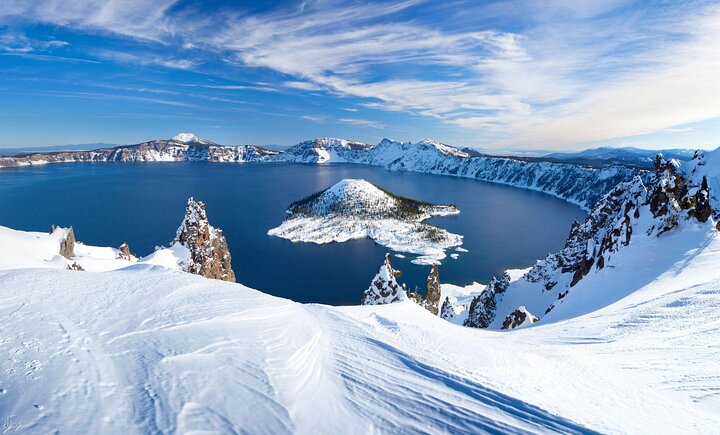 Crater Lake National Park in Oregon, with snow along the rim.